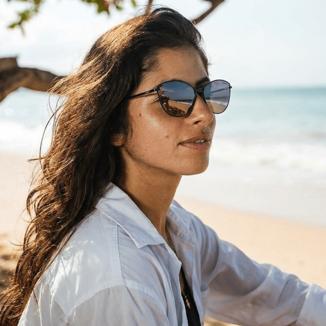 Woman on a sunny beach wearing Layla cat-eye sunglasses