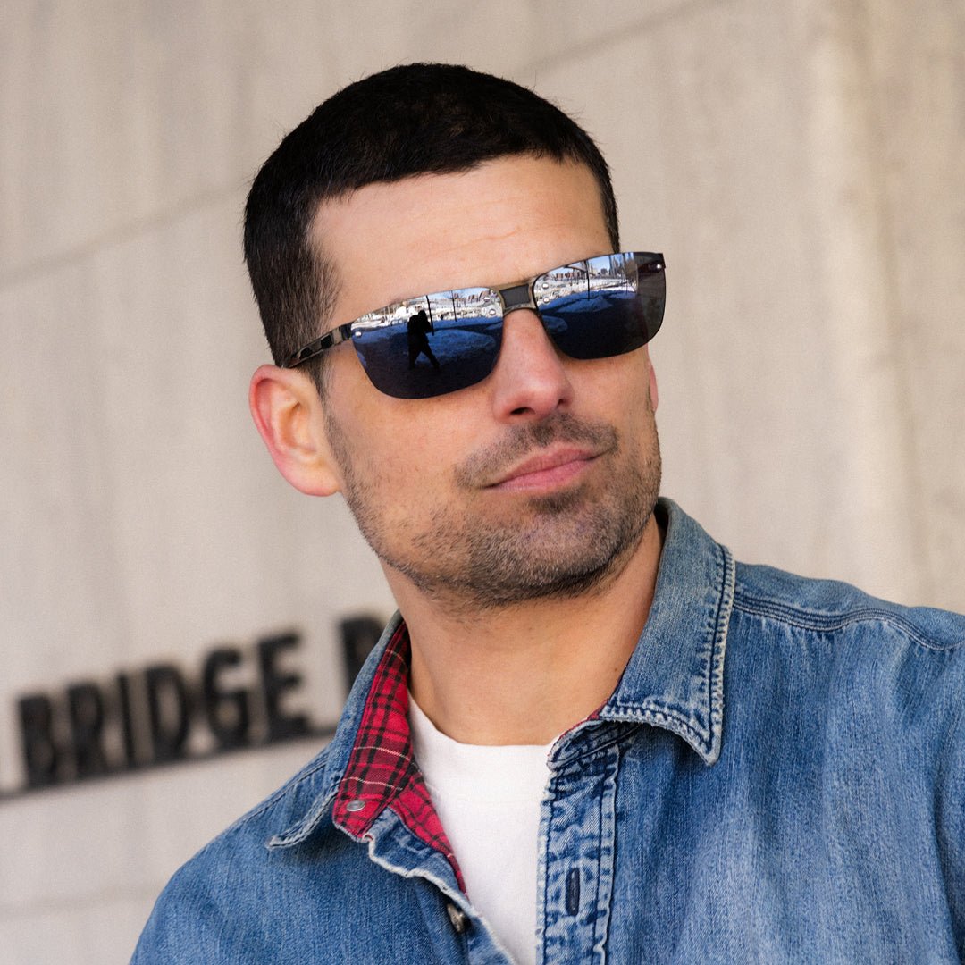 Man wearing Lex rimless sunglasses with reflective lenses and a denim jacket